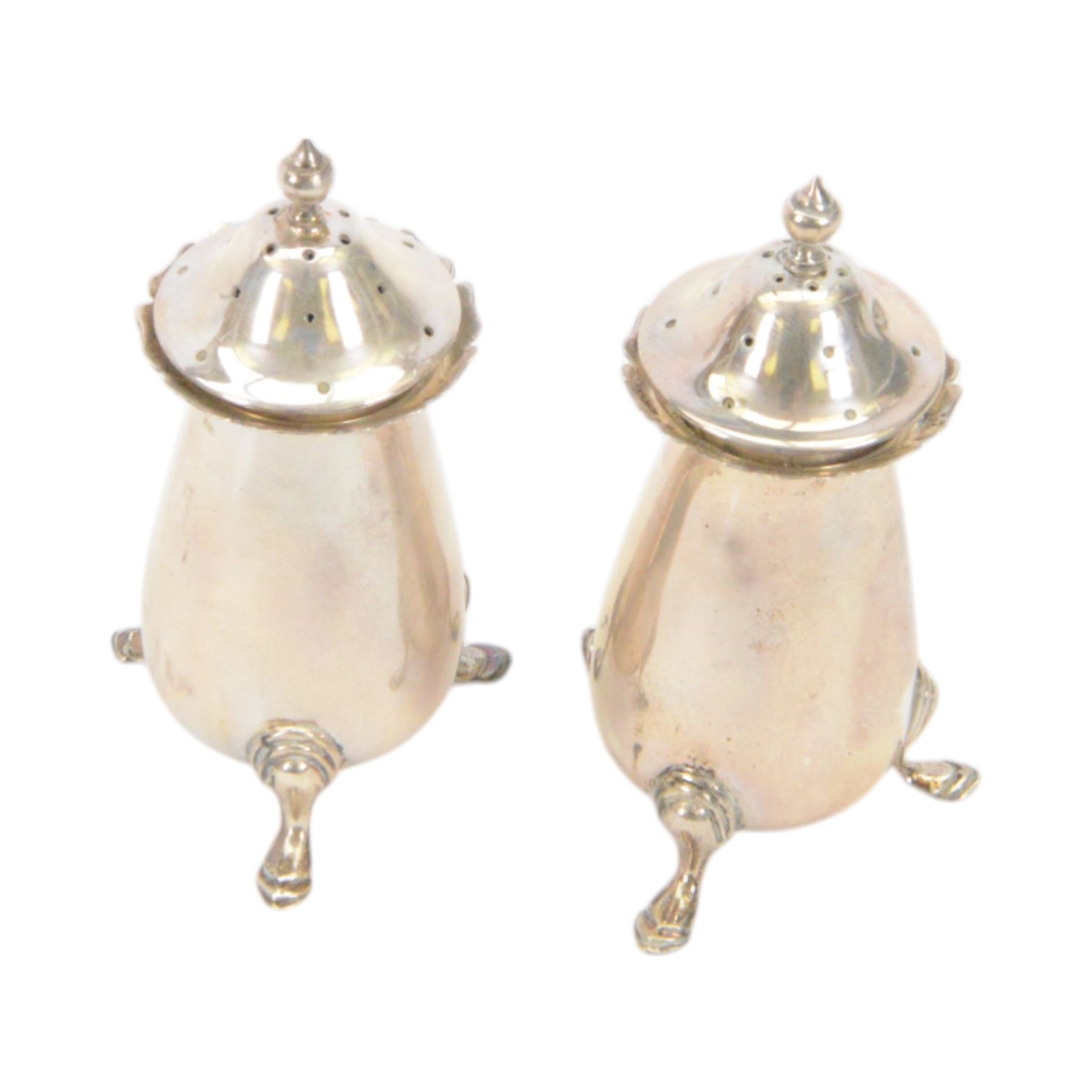 Edwardian silver sauce boat, of typical plain form with shaped rim, with flying C scroll handle and upon three pad feet, hallmarked Birmingham 1907, maker's mark worn and indistinct, together with a pair of Edwardian silver cruets, of urn form, upon three pad feet, hallmarked Horace Woodward & Co Ltd, Birmingham 1905 and a set of six silver apostle spoons, with matching sugar tongs and sugar sifting spoons, some hallmarked Miller Bros, London 1895 and Charles Boynton, all contained within fitted cases