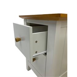 Pair of cream and oak bedside chests, fitted with two drawers