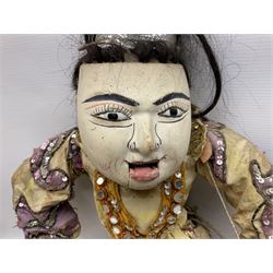 Large string puppet, probably Thai or Burmese, modelled as a woman in traditional costume embellished with sequins, the painted head with articulated mouth, the wood body and hands jointed, L70cm