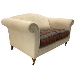 Two seat scroll design sofa, upholstered in cream fabric with check cushions