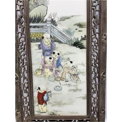 Japanese school framed ceramic panel depicting children in garden scene, signed and inscribed with black script, housed in pierced wood frame, overall L120cm