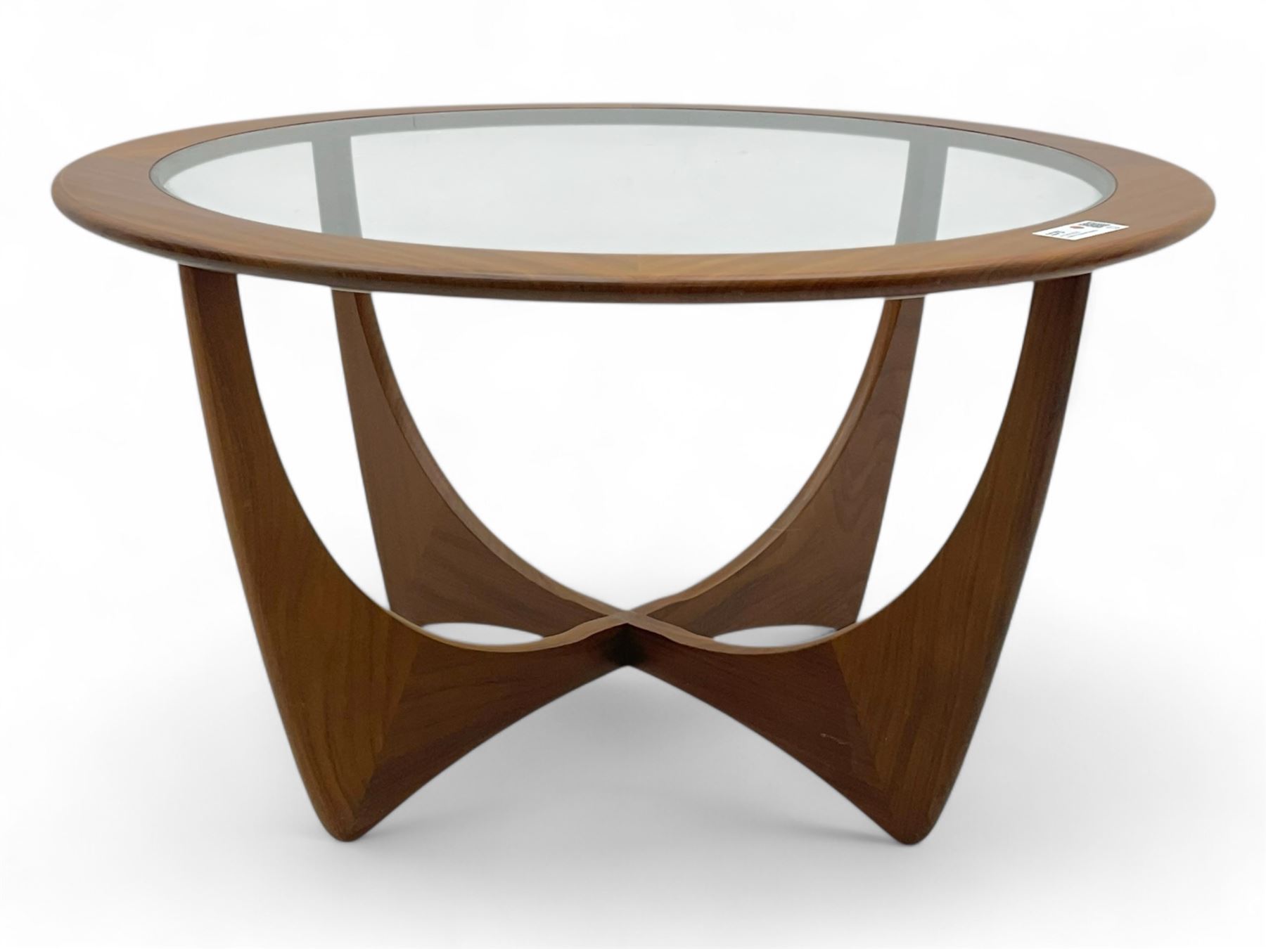 G Plan - Mid-century teak coffee table, circular form with inset glass top within a wide chamfered teak border, on sculptural cruciform base with curved intersecting supports