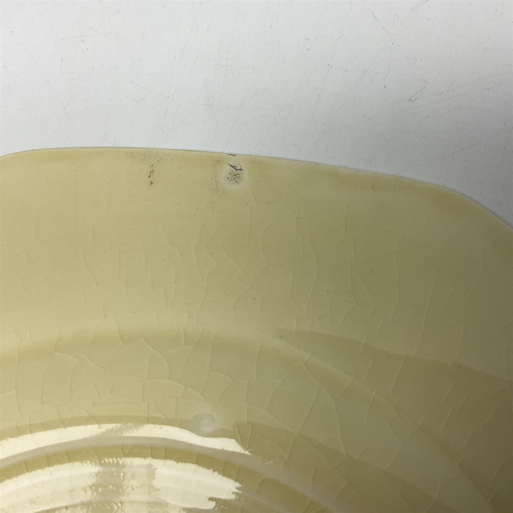 Clarice Cliff Bizarre for Newport Pottery Orange Roof Cottage pattern plate, circa 1932, hand painted with a stylised cottage and bridge landscape with yellow, orange and black banding, black printed mark beneath, D22cm 