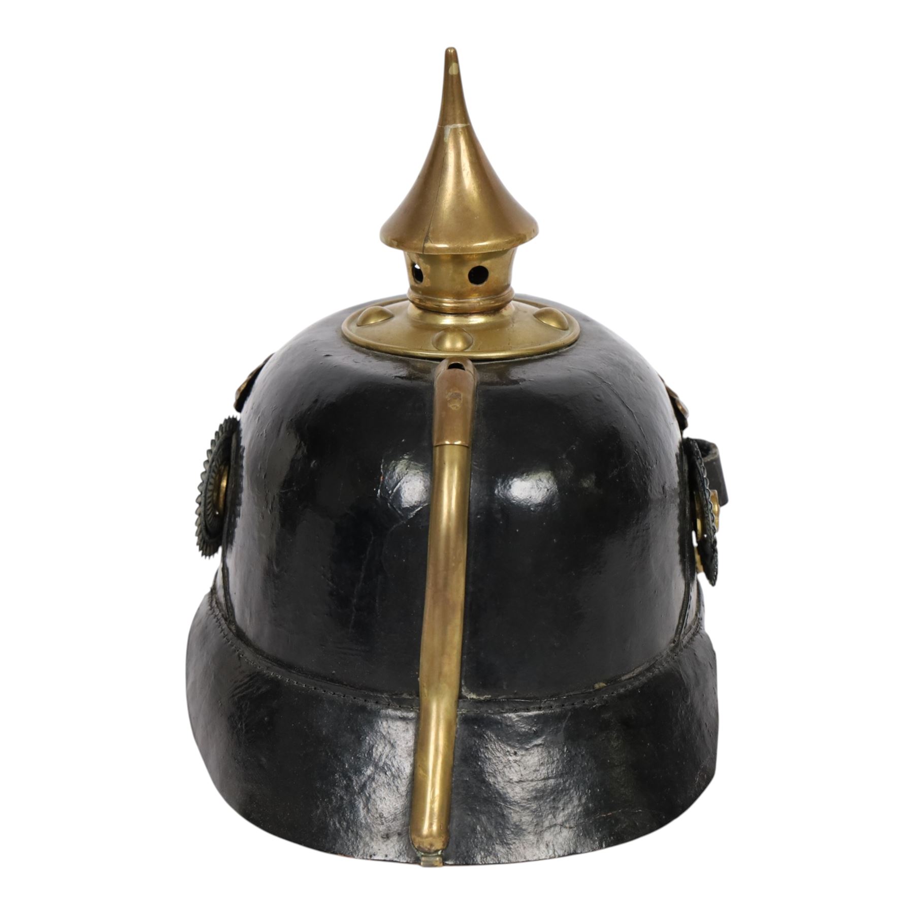 WWI Prussian guard regiment Pickelhaube, the black leather skull with brass ball finial, brass eagle helmet plate and leather chin strap, one side with a black  and white cockade, the other black, white and red, 
