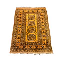 Bokhara gold ground rug, the field decorated with four Gul motifs, wide multi-band border, repeating design and decorated with stylised motifs 