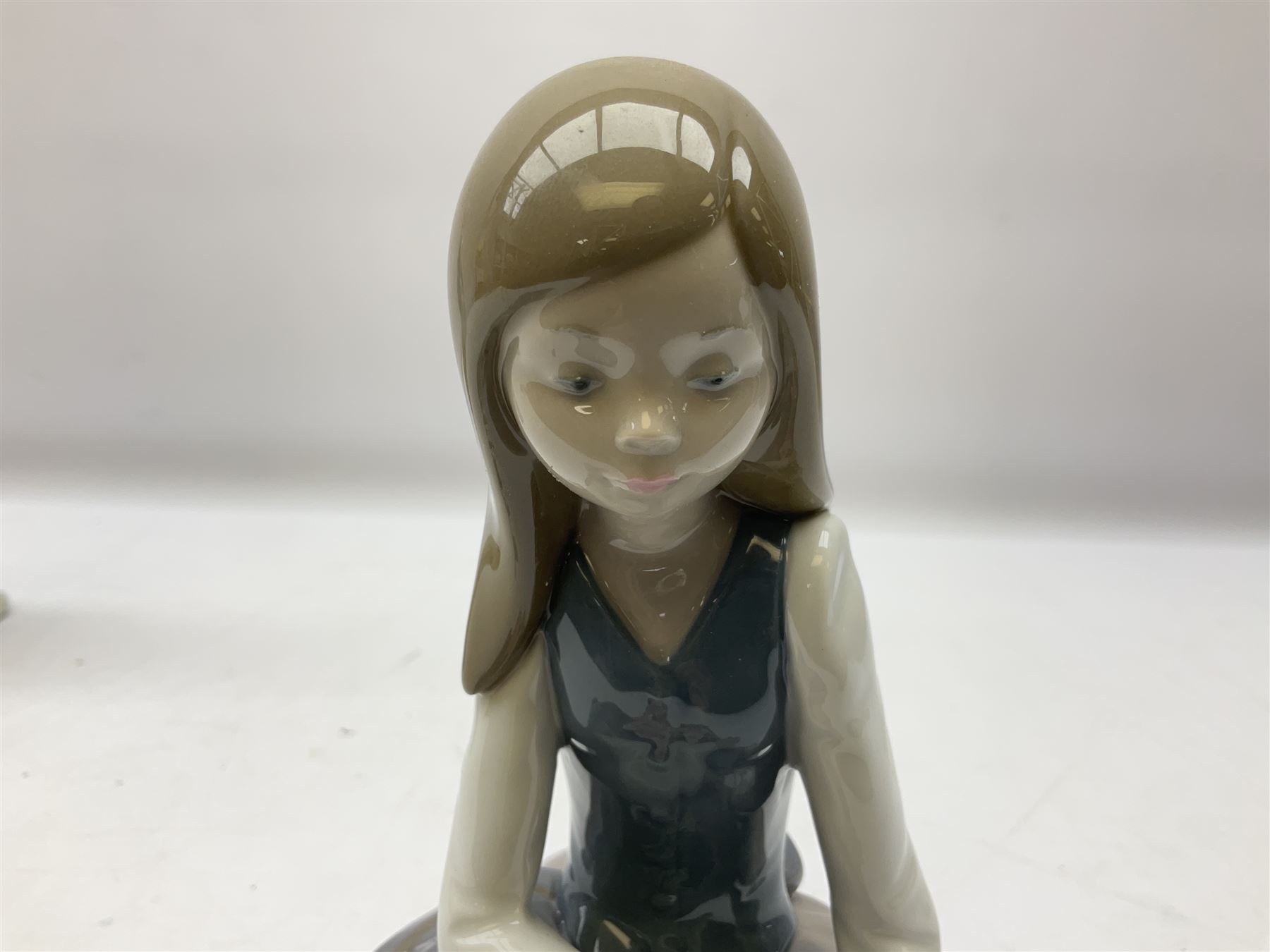 Four Lladro figures, comprising Afternoon Promenade no 7636, Nostalgia no 5071, both with original boxes, Girl with Lilies no 4972 and Madonna no 4534, largest example H27cm