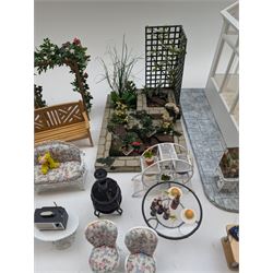 1:12 scale dolls house conservatory and garden accessories, including white wooden glazed conservatory on a stone effect base, black and white metal garden seating, barbecue, plant shelves, parasol, barbeque accessories, large planters, rabbit hutch, animals, chimenea, etc