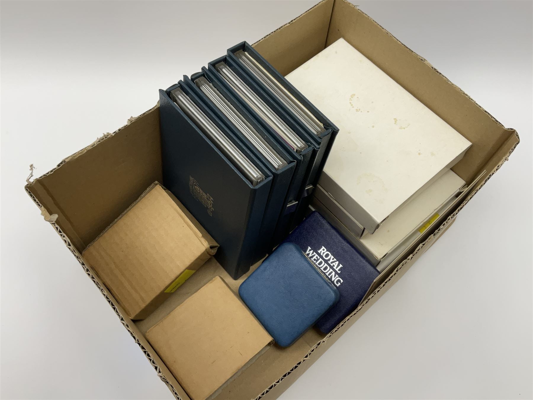 Five Royal Mint United Kingdom proof coin collections dated 1983, 1984, 1985 and 1986, all in blue folders with certificates, silver proof 1981 crown and a sterling silver medal 'Commemorating the marriage of HRH Prince Andrew and Miss Sarah Ferguson at Westminster Abbey 23 July 1986' weighing 37 grams, both cased with certificates (6)