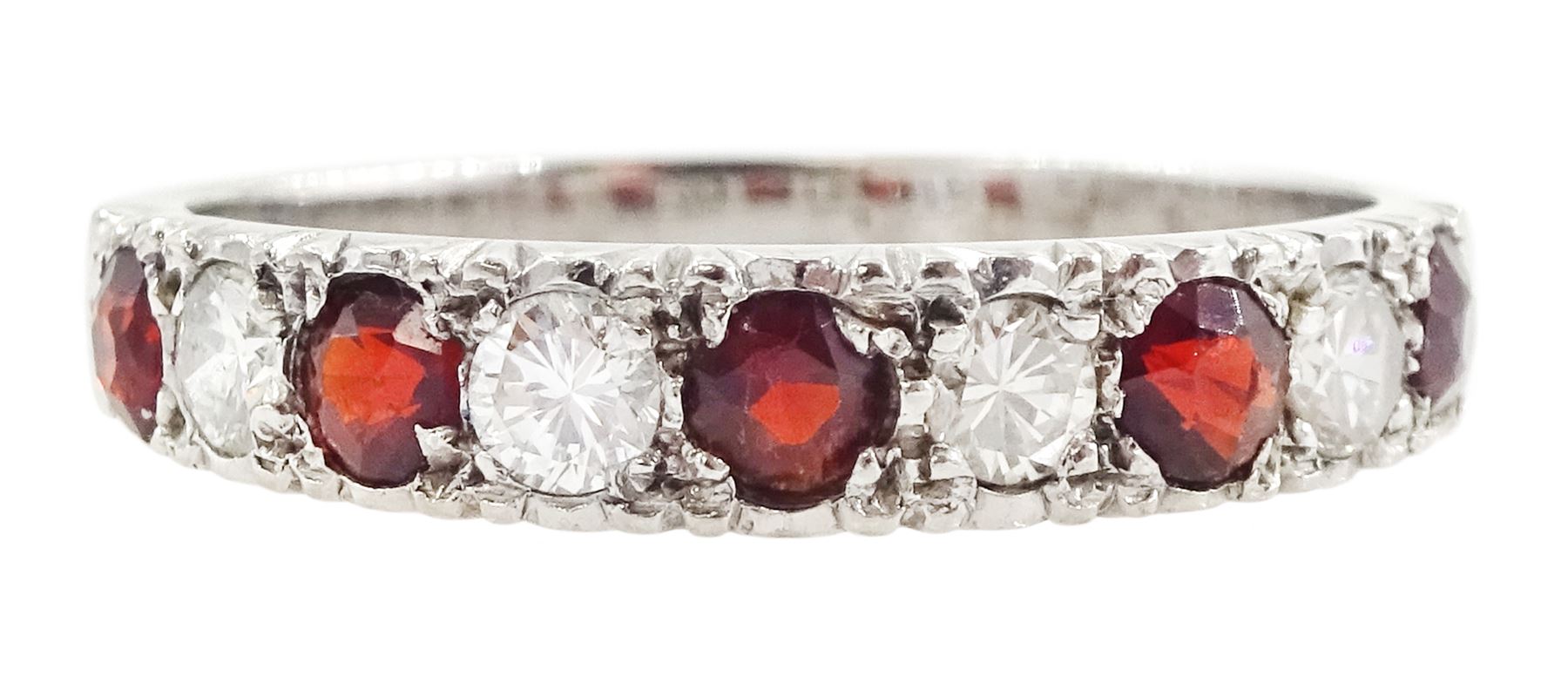White gold garnet and diamond half eternity ring, nine alternating round brilliant cut diamonds and round cut garnets, stamped 18ct, total diamond weight approx 0.30 carat