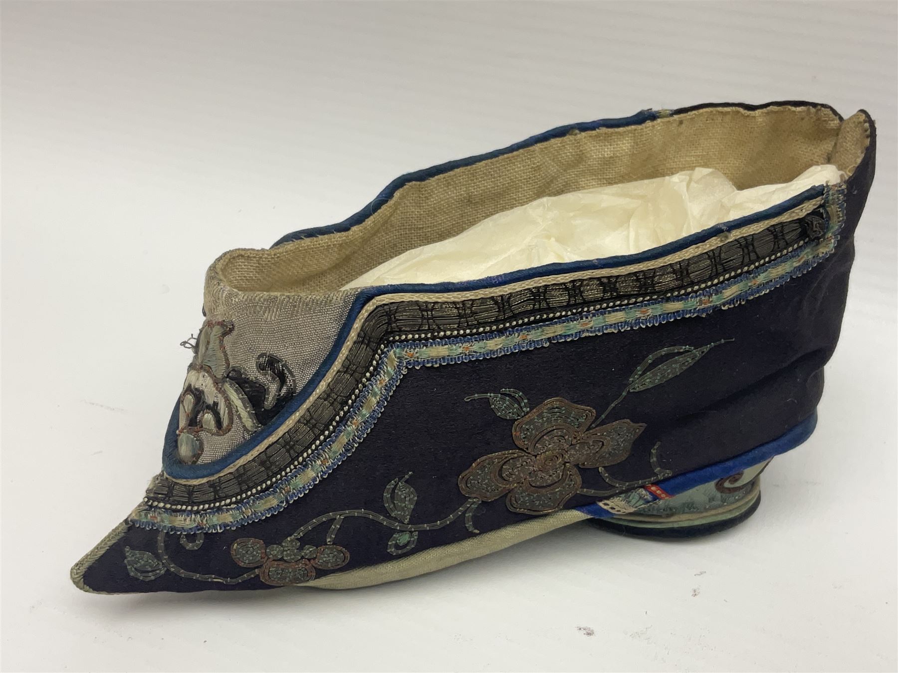 Pair of Chinese silk embroidered lotus shoes, for bound feet, a blue ground with floral detailing L15cm