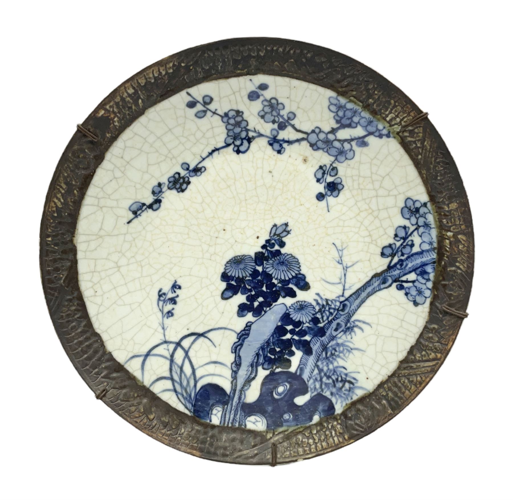 20th century Chinese blue and white crackle glaze charger, decorated with peonies, prunus blossom, and rockwork, within simulated bronze border, with character mark verso, D34cm