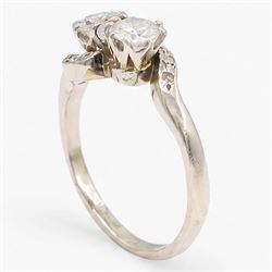 Platinum diamond crossover ring, set with two round brilliant cut diamonds and diamond set shoulders, stamped, total diamond weight approx 0.65 carat