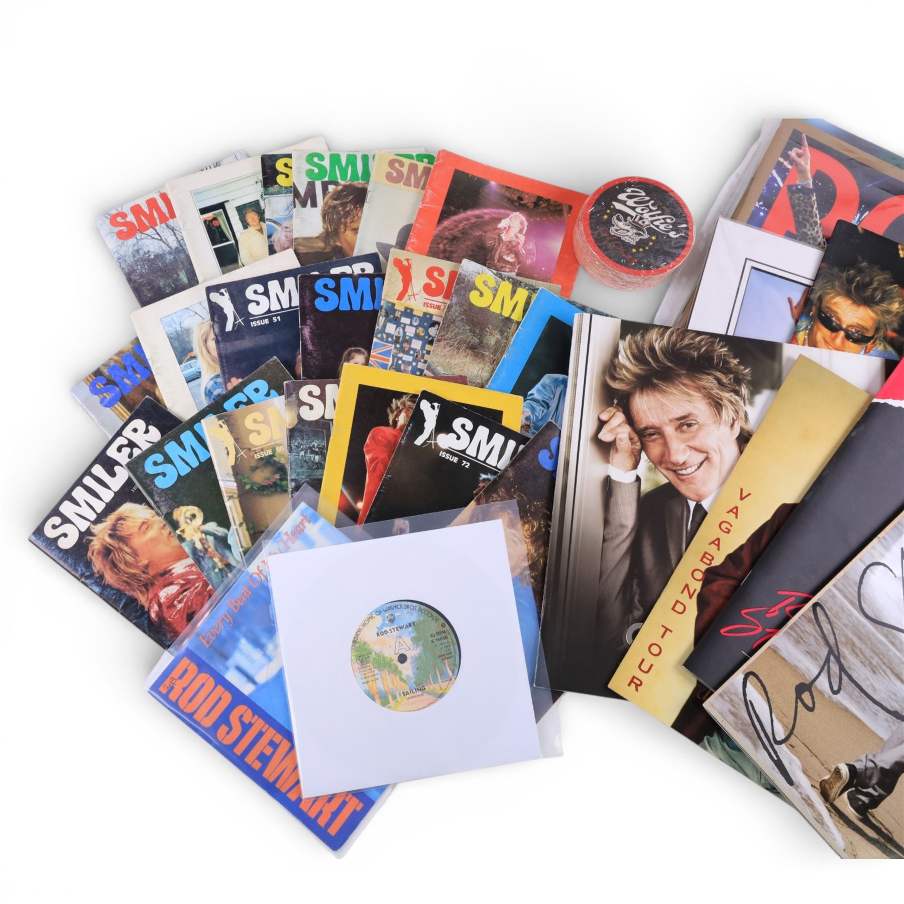 Signed bottle of Rod Stewart edition Wolfie's blended scotch whisky, together with Rod Stewart memorabilia, including first edition of his autobiography, colour photograph and two 7 inch singles, DVD sleeve 'Rod Stewart Live at Royal Albert Hall' signed by both Rod Stewart and Penny Lancaster, framed, tour programmes including 2019 world tour and a collection of Fan Club magazines