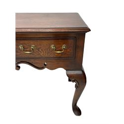 Georgian design oak and mahogany dresser base, the rectangular moulded top with mahogany band, three cocked-beaded and banded drawers over shaped a pierced apron, circular brass handle plates and swan neck handles, on C-scroll carved cabriole supports 