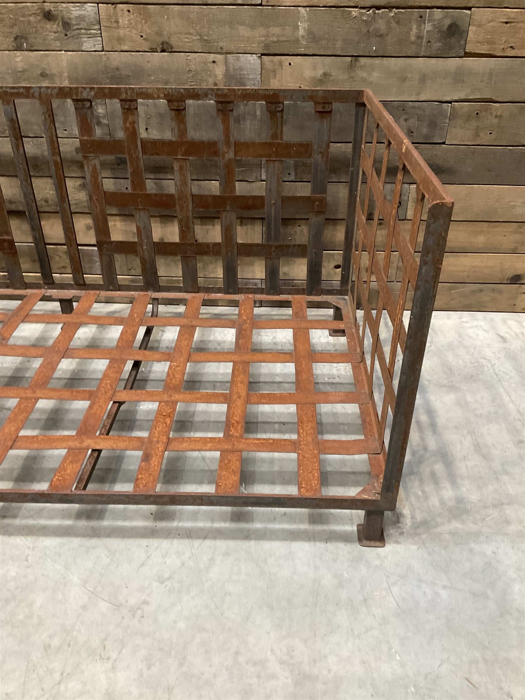 Wrought iron strapwork garden day bed, lattice back and sides