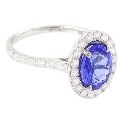 Platinum tanzanite and diamond cluster ring, single oval tanzanite of 2.36 carat, with round brilliant cut diamond surround and diamond set shoulders, hallmarked, total diamond weight 0.76 carat, with World Gemological Institute report