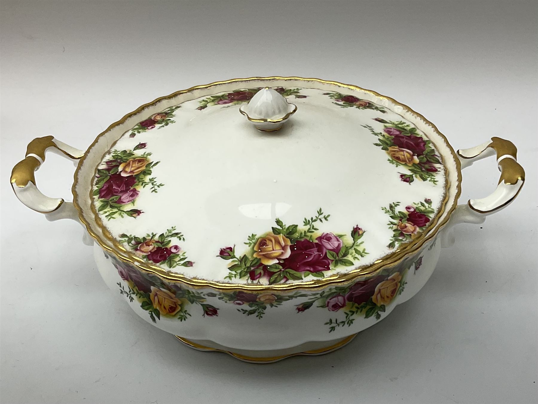 Royal Albert Old Country Roses part dinner and tea service comprising teapot, four tea cups and saucers, eight dessert plates, cake plate, cake stand, a tureen with cover, six dinner plates, an oval dish, two trinket dishes, bell and shoe decoration. 
