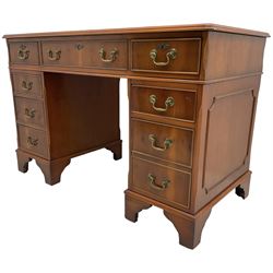 Georgian design yew wood twin pedestal desk, rectangular top with green leather inset writing surface, fitted with nine cock-beaded drawers, on bracket feet