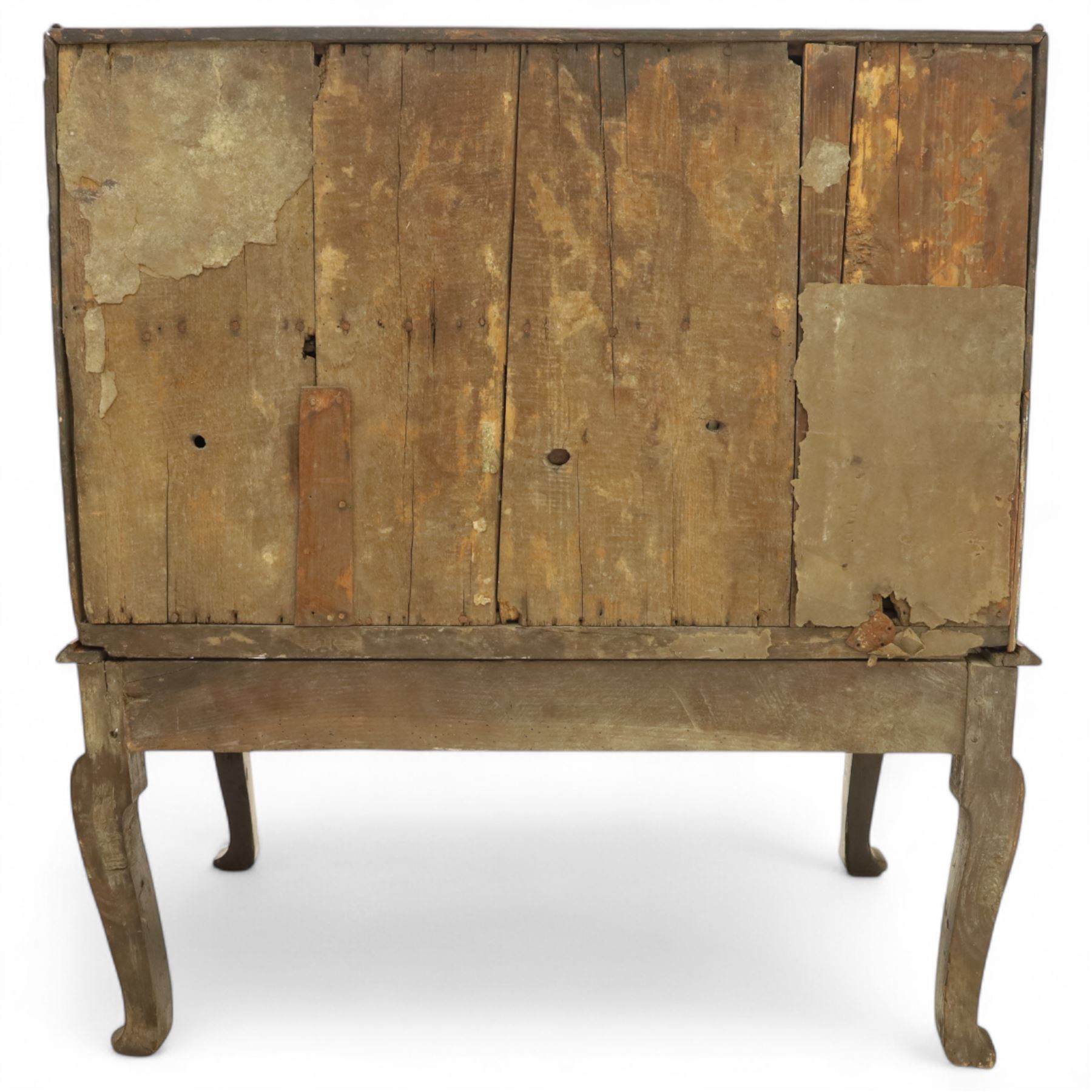 Early 18th century George I oak bureau on original stand, the fall front enclosing an arrangement of correspondence drawers and pigeonholes over central well, fitted with single long drawer below, the shaped apron over cabriole supports with pad feet