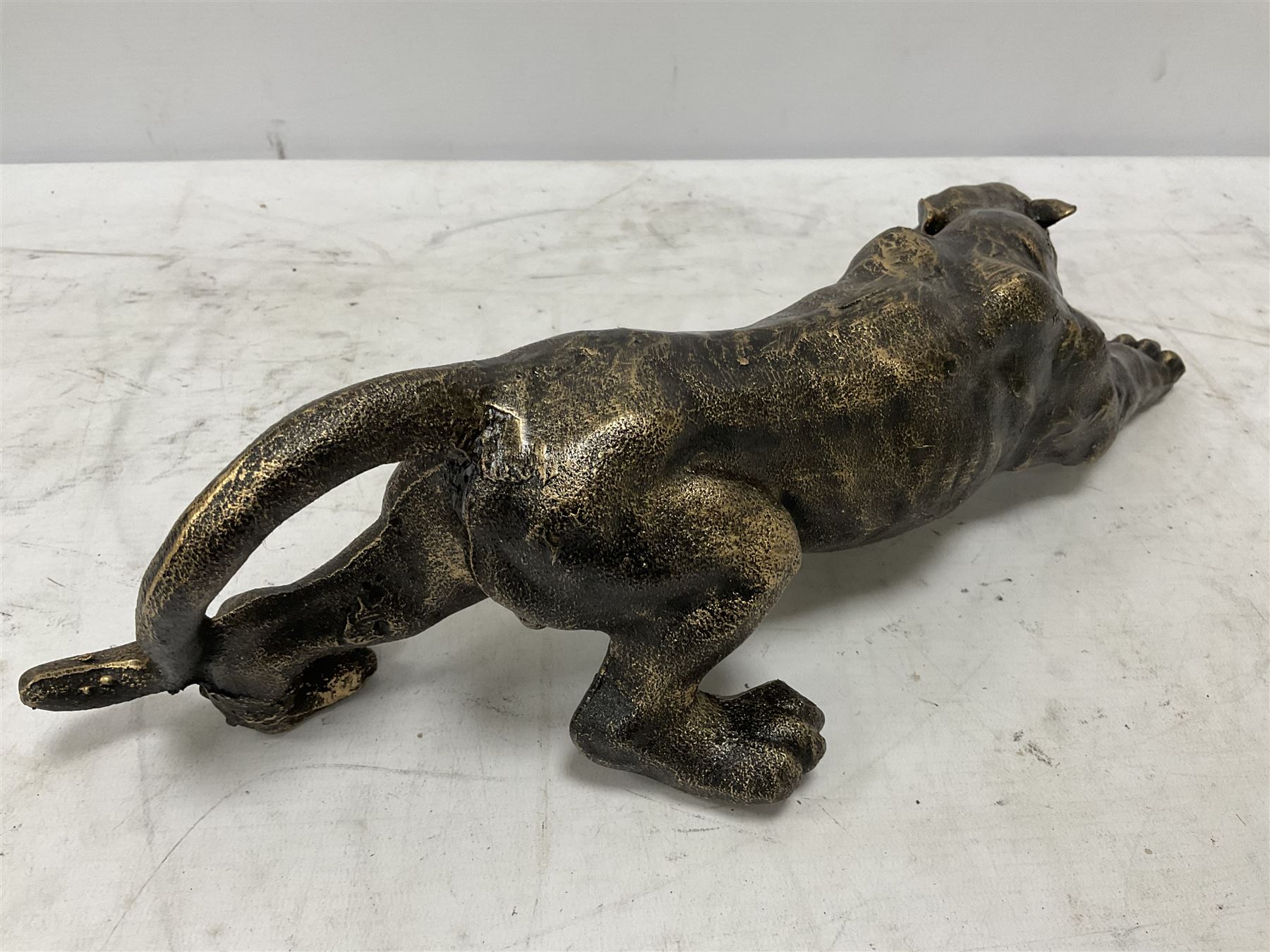 Cast metal figure modelled as a cougar in crouching pose, L40cm