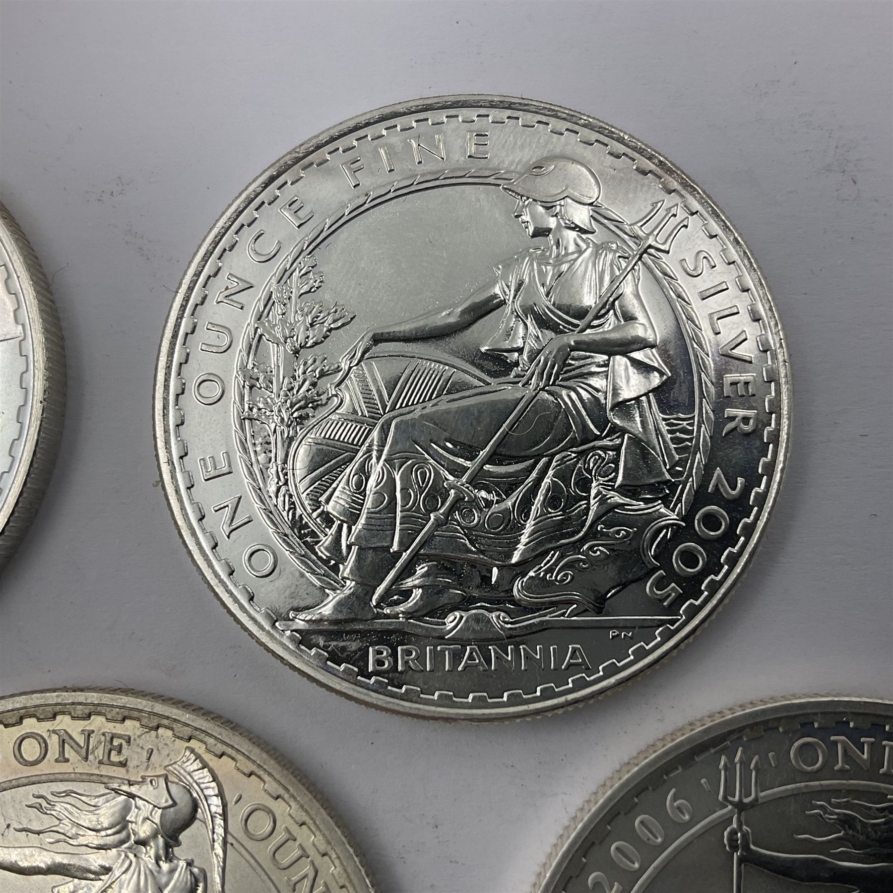 Five Queen Elizabeth II United Kingdom one ounce fine silver Britannia two pound coins dated 2002, 2003, 2004, 2005 and 2006