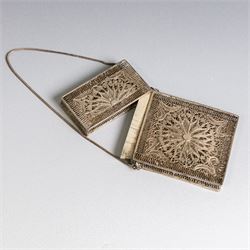 Early 20th century silver coin purse, with floral decoration and finger chain, hallmarked together with an early 20th century cigarette case,  with engraved initials, hallmarked and a silver filigree cigarette case