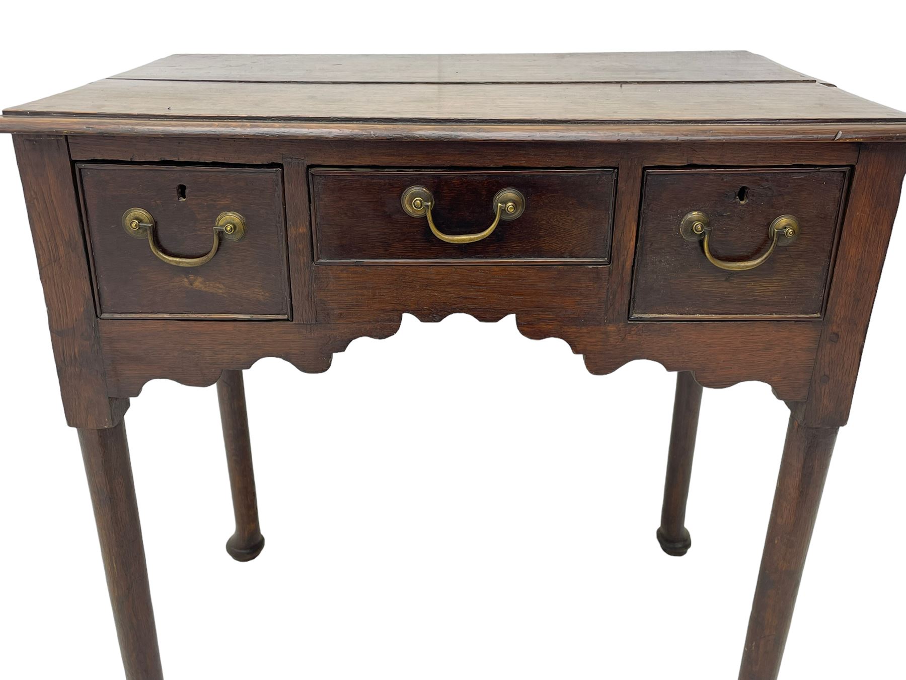 18th century oak low-boy, ovolo-moulded rectangular top over three cock-beaded drawers, circular brass handle plates and D-shaped handles, shaped and stepped arched apron, on cabriole supports 