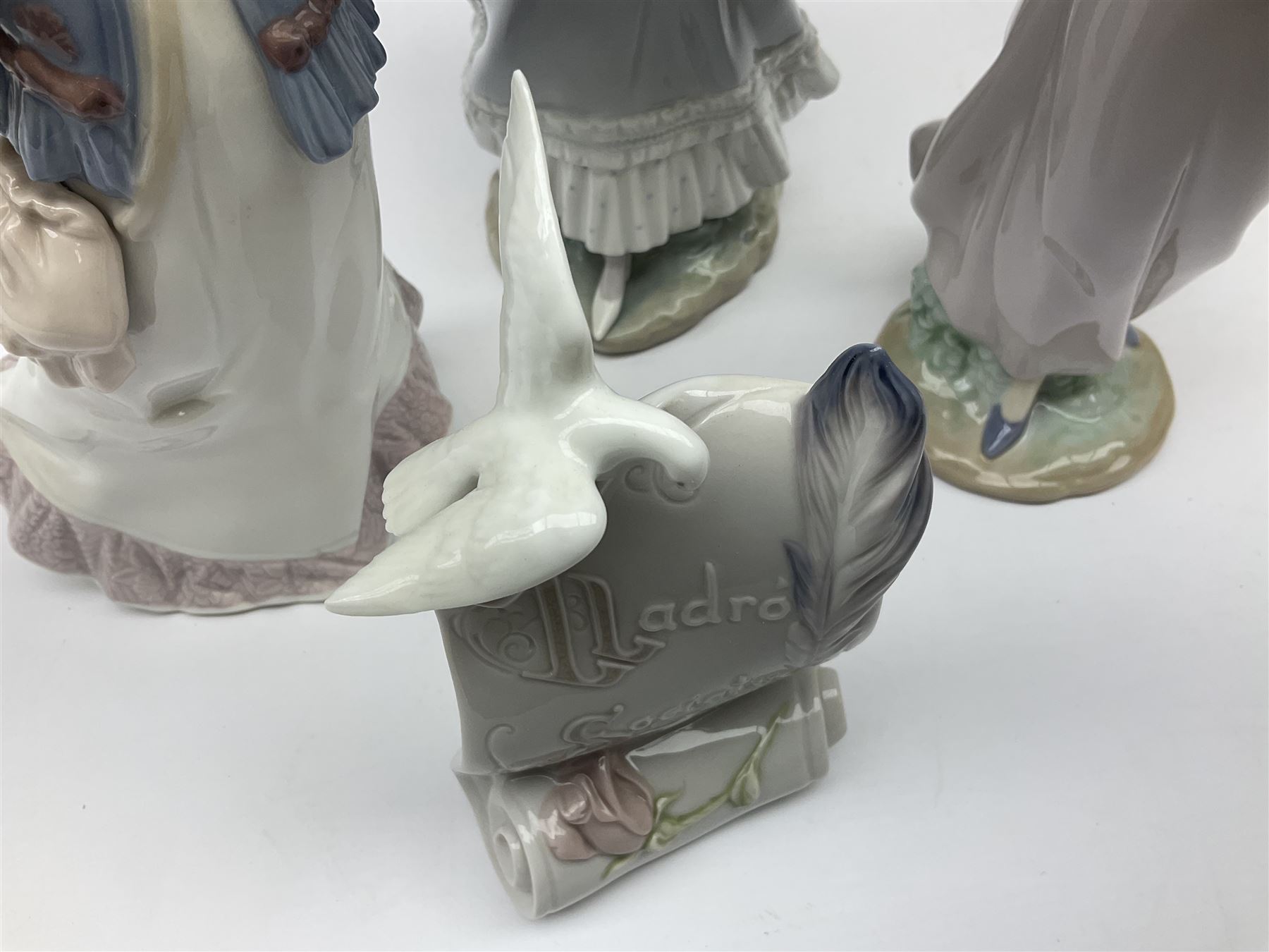Three Lladro figures, comprising, Dreams of Summer Past no 6401, Spring Breeze no 4936 and Breezy Afternoon 5682 together with Lladro plaque Art Brings us Together no 7677, all in original boxes, largest example H35cm