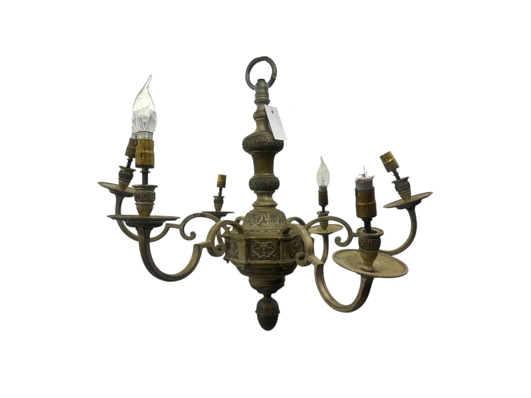Pair of mid-20th century brass chandeliers, each with cast foliate and scroll decorated central body, issuing six scrolling arms with circular drip pans and bulb holders, suspended from integral ceiling loops