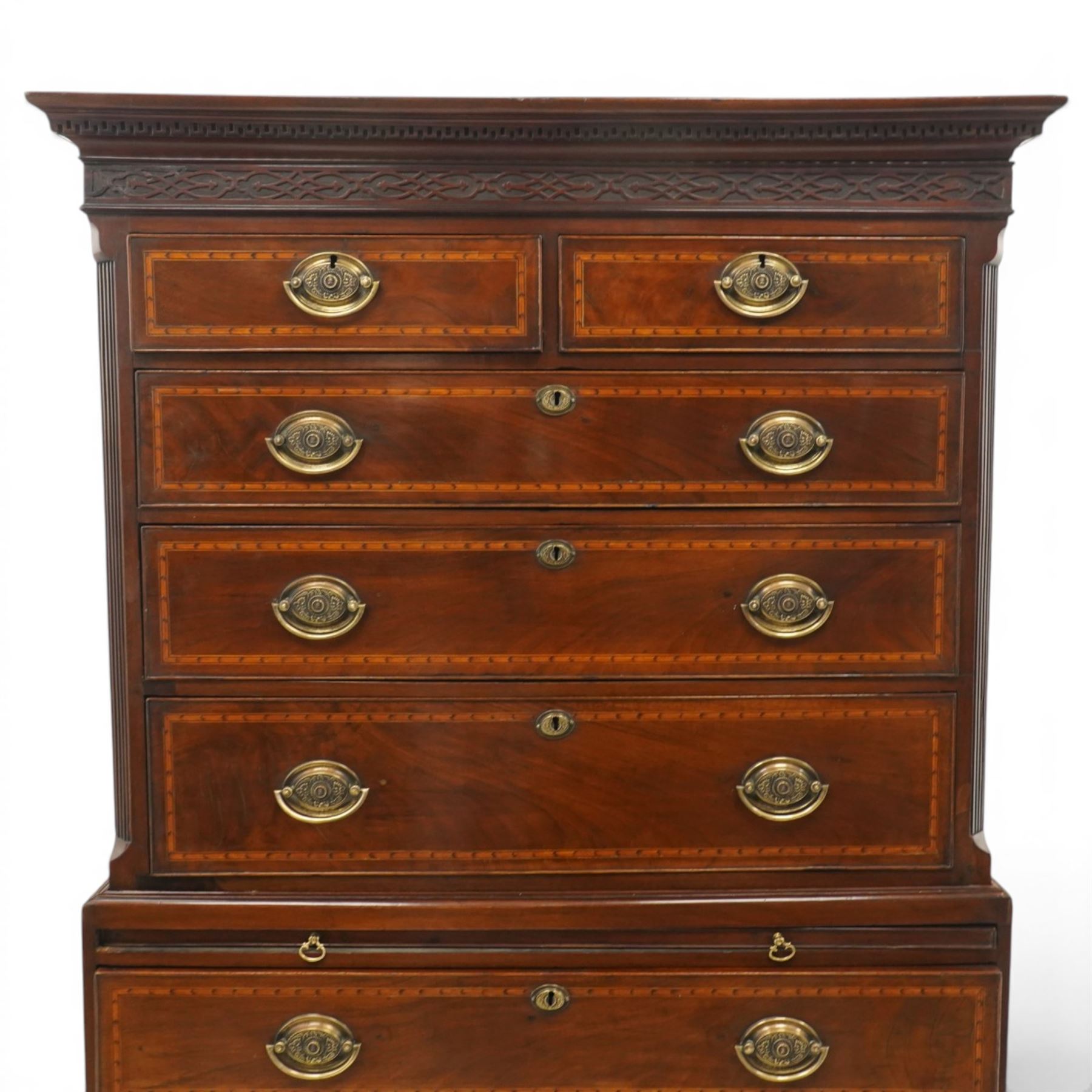  Late 18th century mahogany and inlaid chest on chest, projecting cornice above blind fretwork in laid drawers, the upper chest with two short over three graduating drawers, the lower section with brushing slide over three long graduated drawers, raised on bracket feet