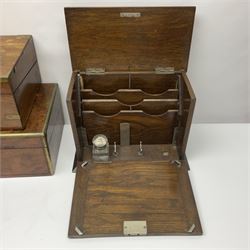 Early 20th century oak correspondence box, with black silver plated shield cartouche to cover, opening to reveal letter rack, glass inkwell and pen holder, together with two brass bound writing slopes and an Edwardian smokers cabinet with embossed metal panel to door, tallest H29cm