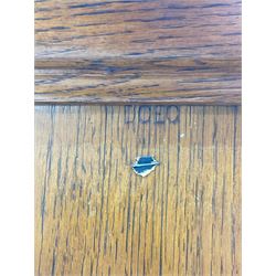 The North of England School Furnishing Company Limited Darlington - early 20th century oak school cupboard, projecting moulded cornice over two panelled doors, fitted with shelves, on chamfered plinth base 