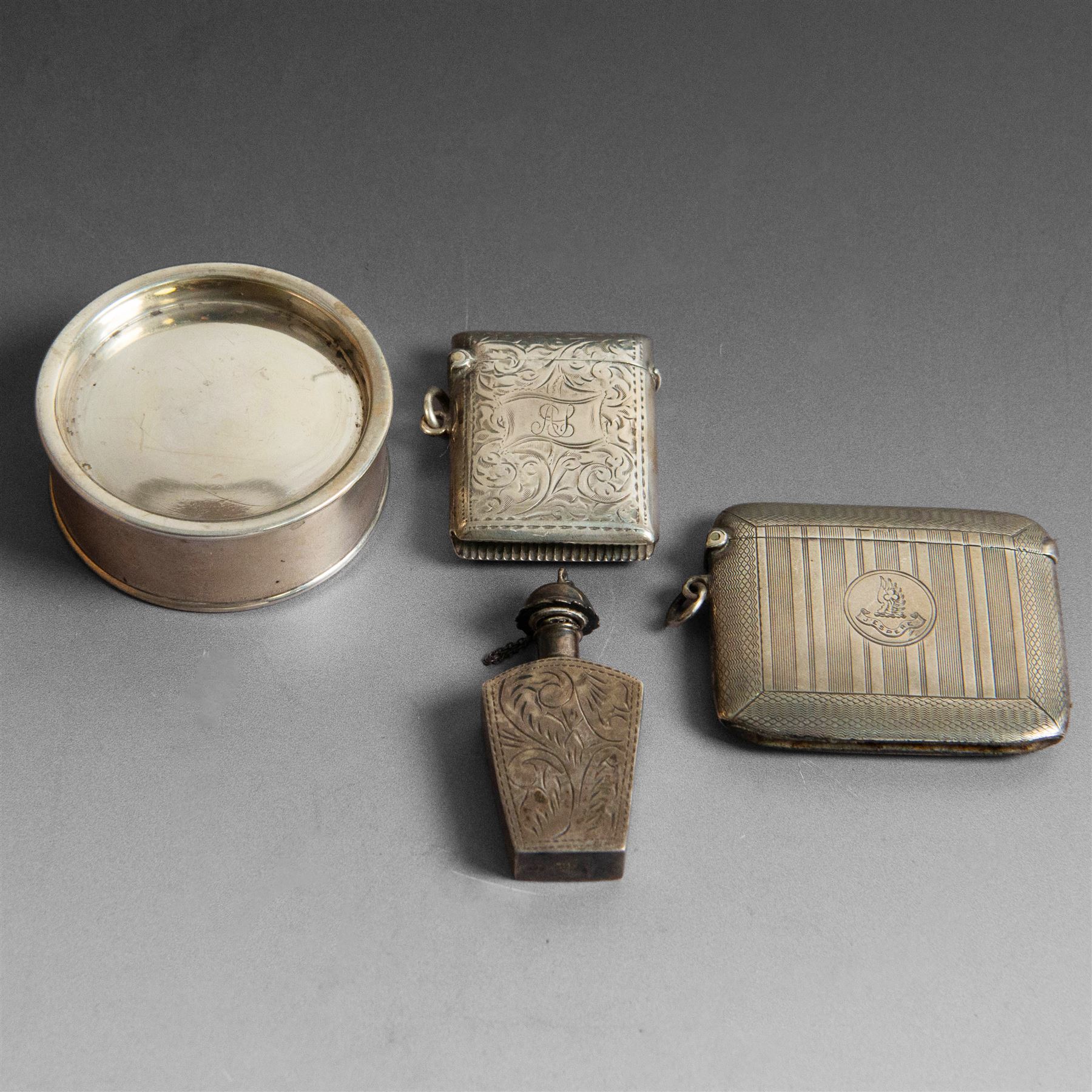 Two silver vesta cases, comprising early 20th century example with engine turned decoration, engraved 'J'espere' (I hope), hallmarked William Neale & Son Ltd, Birmingham 1912 and a small rectangular example with engraved decoration and initials, together with a small silver box, of plain circular form and a small silver scent bottle, all with import marks or A