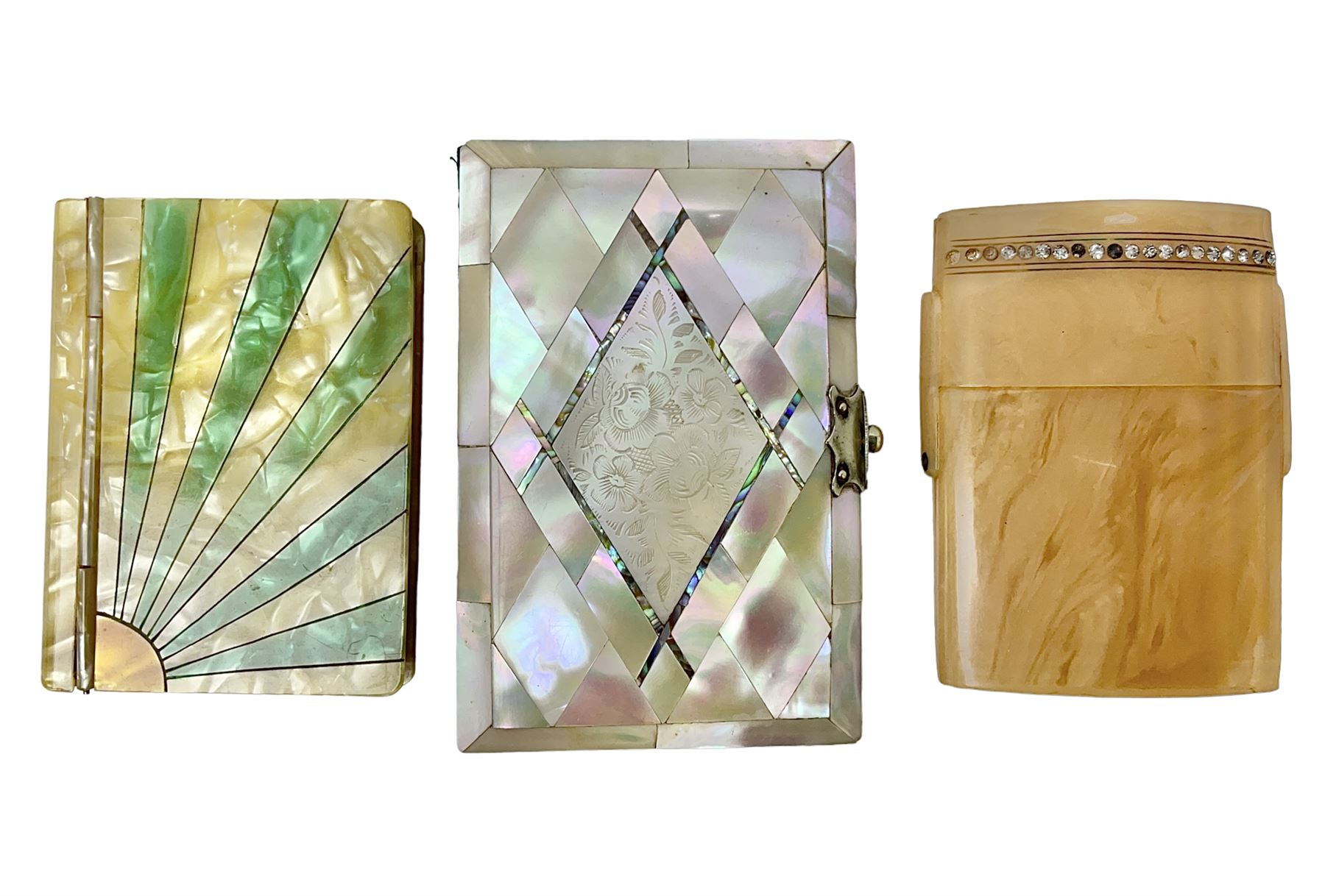 Mother of pearl and abalone inlaid card case, with central diamond shaped panel engraved with foliate decoration, together with a simulated mother of pearl card case of book form with green sun rays to cover, and simulated wood effect cigarette case with hinged lid with diamante style banding, largest L10cm