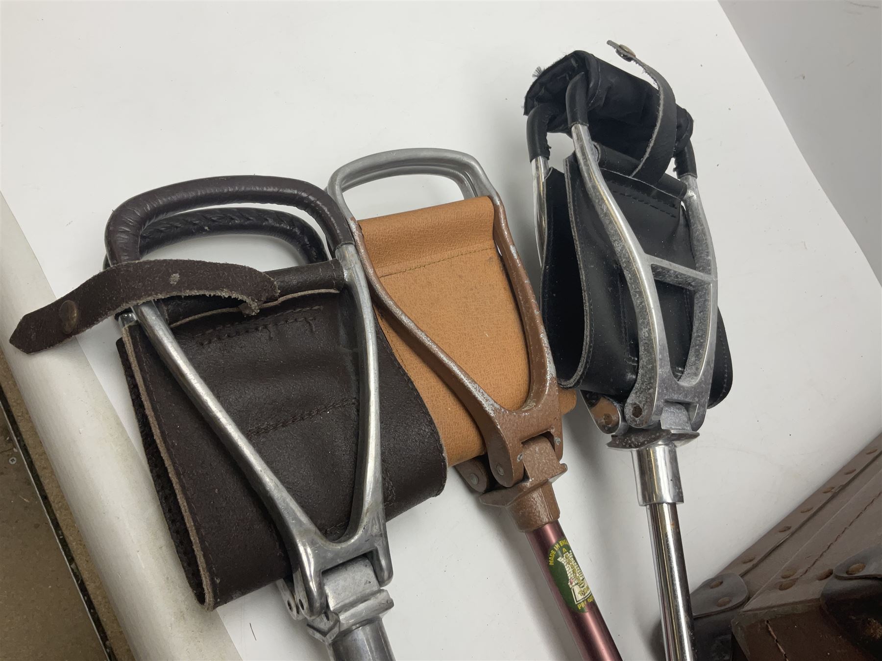 Three shooting sticks, together with four vintage leather brown suitcases of various sizes, largest suitcase H40cm L65cm 