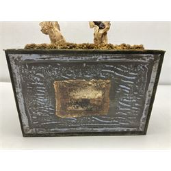 Modern reproduction automaton in the form of a baby doll in a basket clothed in Victorian style lace bloomers and frilled bonnet; clockwork action; on raised platform; with French paper label on base, 29cm wide,