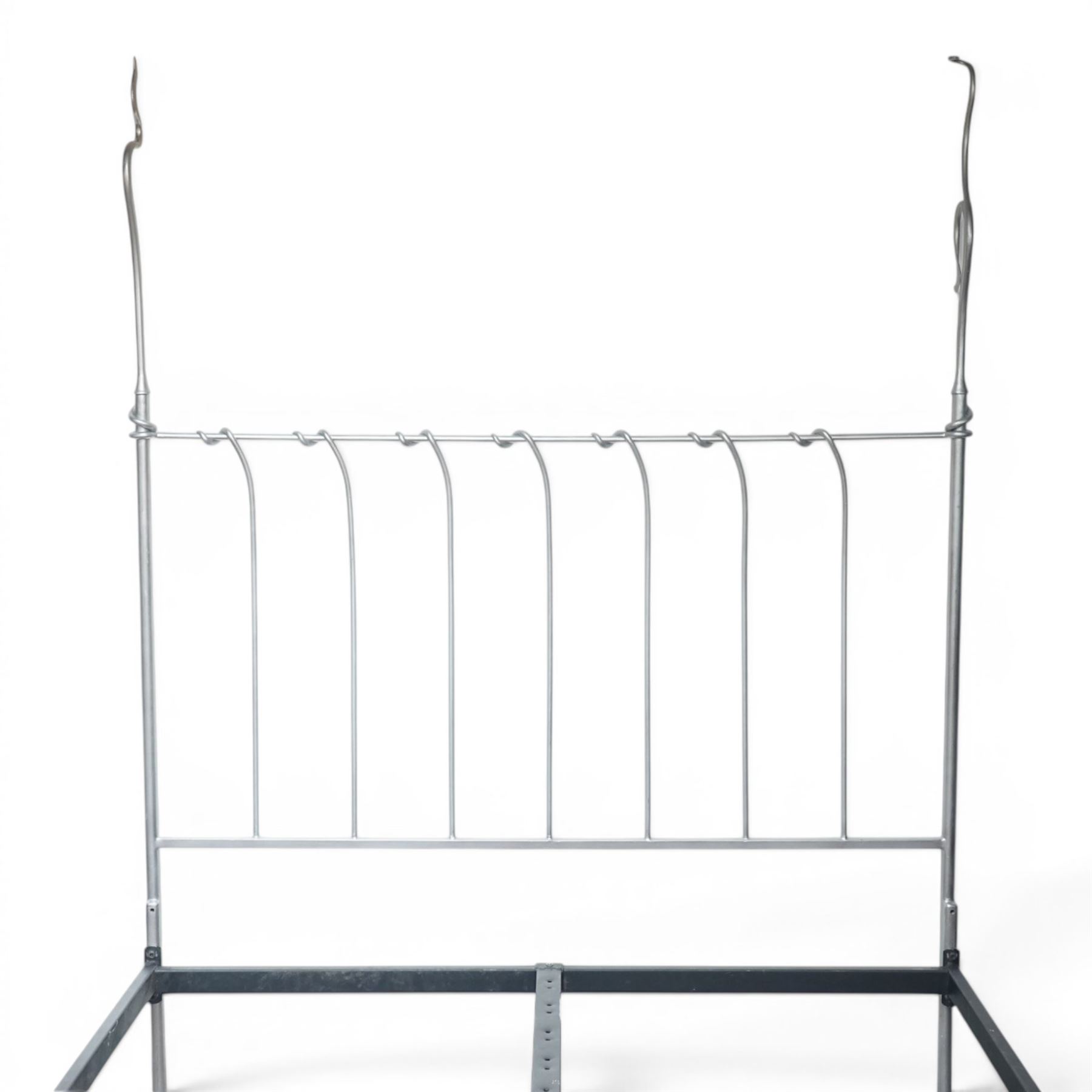 And So To Bed - 'Squigalina' silvered metal framed 5ft king size four poster bed, the tubular chrome posters in scrolling foliate form, over a shaped and scroll-topped metal spindle headboard and footboard