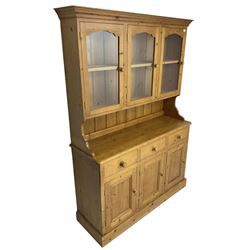 Sterling Interiors - traditional pine kitchen dresser, the rack fitted with three glazed doors enclosing single shelf, the base with three drawers over three panelled cupboard doors, on plinth base