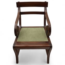 In the manner of Morgan & Sanders - early 20th century Regency design mahogany metaphoric library chair and steps, rectangular panelled top-rail with applied roundels with scrolling arms and upholstered seat and cushion, hinged and folding design transforming into four carpeted steps

Reference: The present lot is based on a design for a metamorphic library chair published by Morgan & Saunders circa 1810, P.Agius, Ackermann's Regency Furniture & Interiors, plate 29, page 60