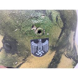 Fully restored German steel helmet, the camouflage painted exterior with two decals and replacement leather liner