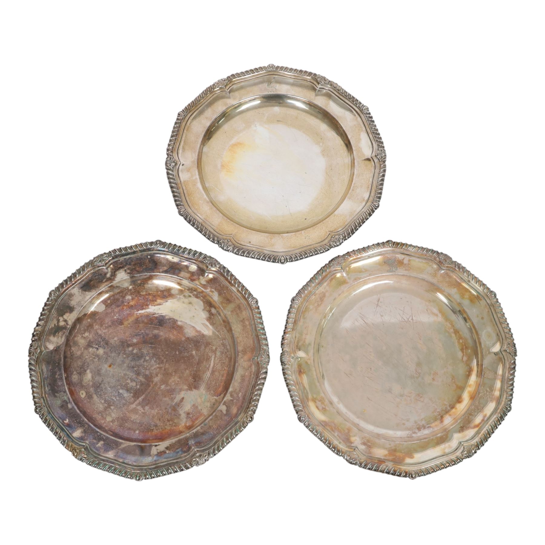 Set of three late 19th century Mappin Brothers silver plated plates, the pie crust rims with oblique gadrooned edge, each engraved with dragon armorial crest, D26cm