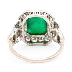 18ct white gold and platinum emerald and diamond cluster ring, single octagonal cabochon cut emerald, surrounded by sixteen milgrain set round cut diamonds, the shoulders set with baguette and single cut diamonds, stamped 18ct, total diamond weight approx 1.55 carat