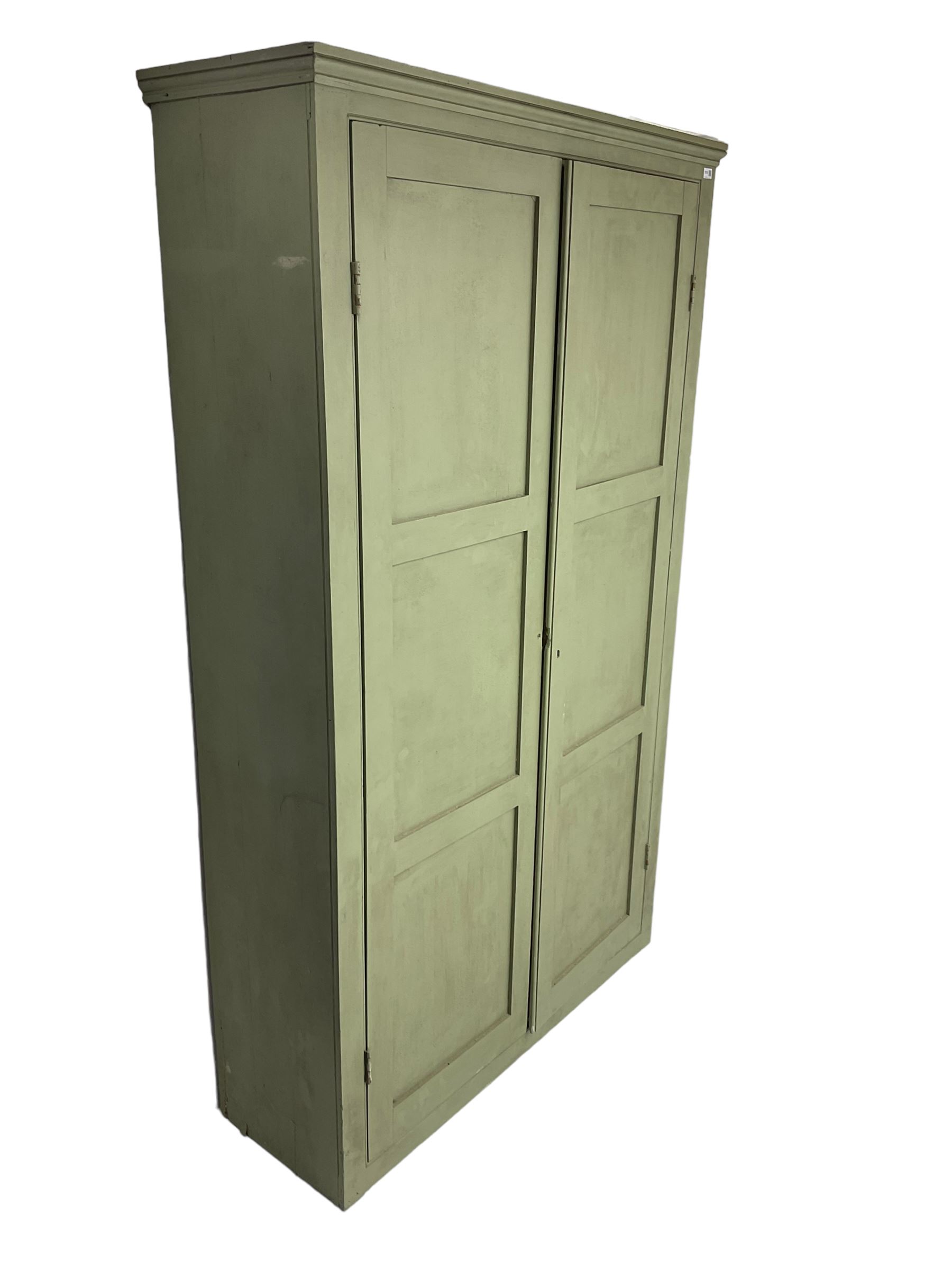 Painted pine cupboard, two panelled doors enclosing four shelves, in laurel green finish