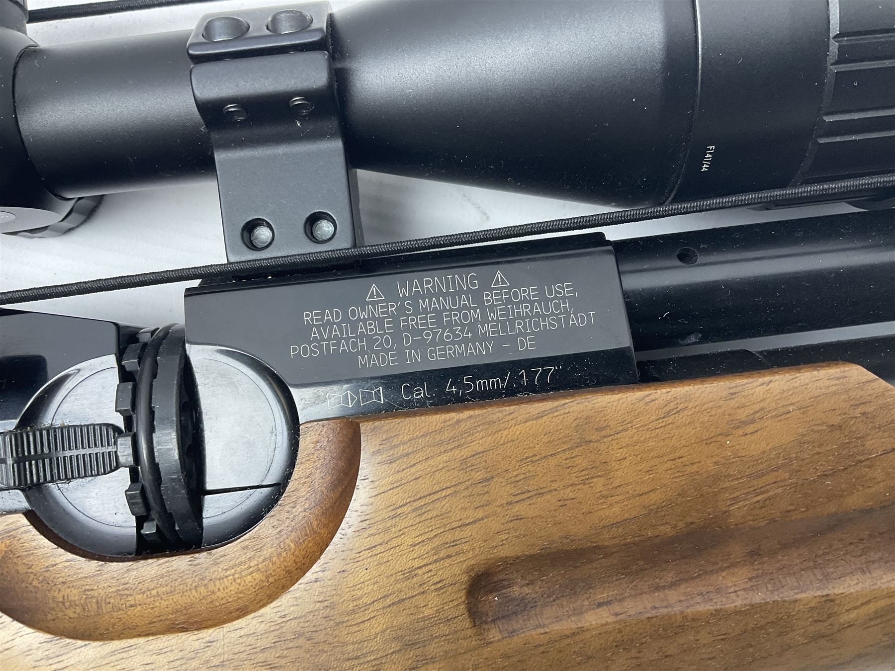 Weihrauch Sport HW100 .177 calibre PCP repeating air rifle; walnut thumbhole stock with textured pistol-grip; fourteen-shot magazine; Nikko Stirling Gameking 3.5 -10x44 illuminated telescopic sight; No.1922087 L90cm overall; in Napier fleece lined gun sling; with re-filling air tank and quantity of pellets NB: AGE RESTRICTIONS APPLY TO THE PURCHASE OF AIR WEAPONS.