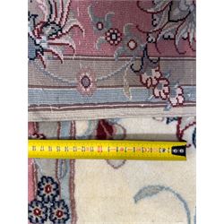 North East Persian Kashmar hand-knotted rug, ivory field with an all-over design of linked floral medallions and scrolling vines with a central circular medallion enclosed by multiple borders and a main broad madder field with palmettes and arabesques, 248cm x 145cm