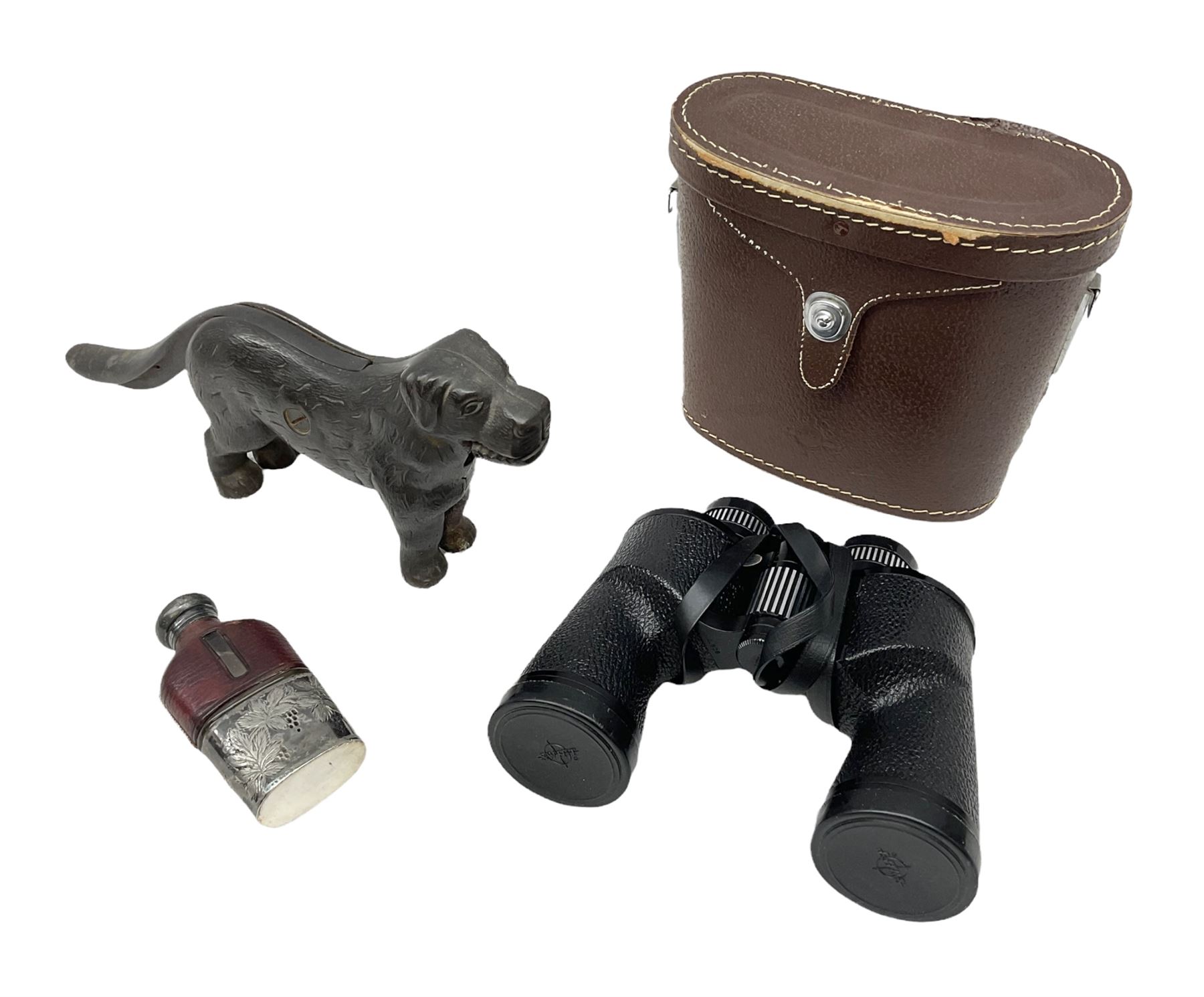 Cast metal nutcracker, in the form of a dog together with a pair of Swift Saratoga 8x40 binoculars in leather case and a hip flask, the glass flask covered in leather to the top with a detachable silver plated cup to base