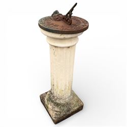 Cast stone garden sundial featuring a cast iron top with Roman numerals and lions head motif