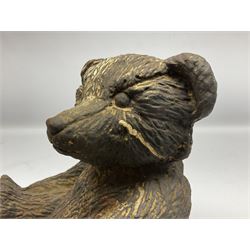 19th century cast iron door stop, modelled as a seated toy bear, with remnants of painted finish, H22.5cm