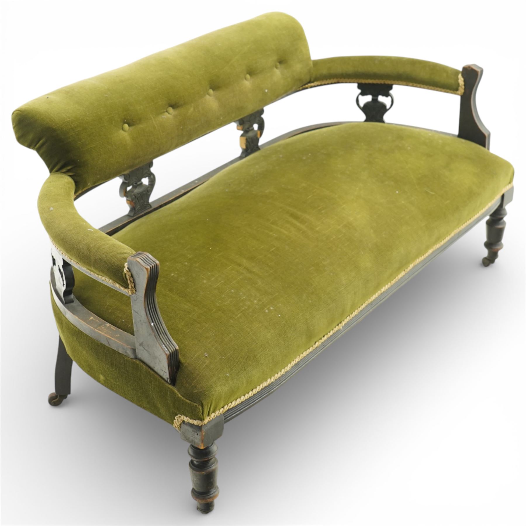 Late 19th century upholstered settee, shaped padded back with a row of button detailing, downswept open arms with upholstered pads, upholstered in olive green velvet, the frame with moulded rails and raised on turned front supports and out-swept rear legs with castors