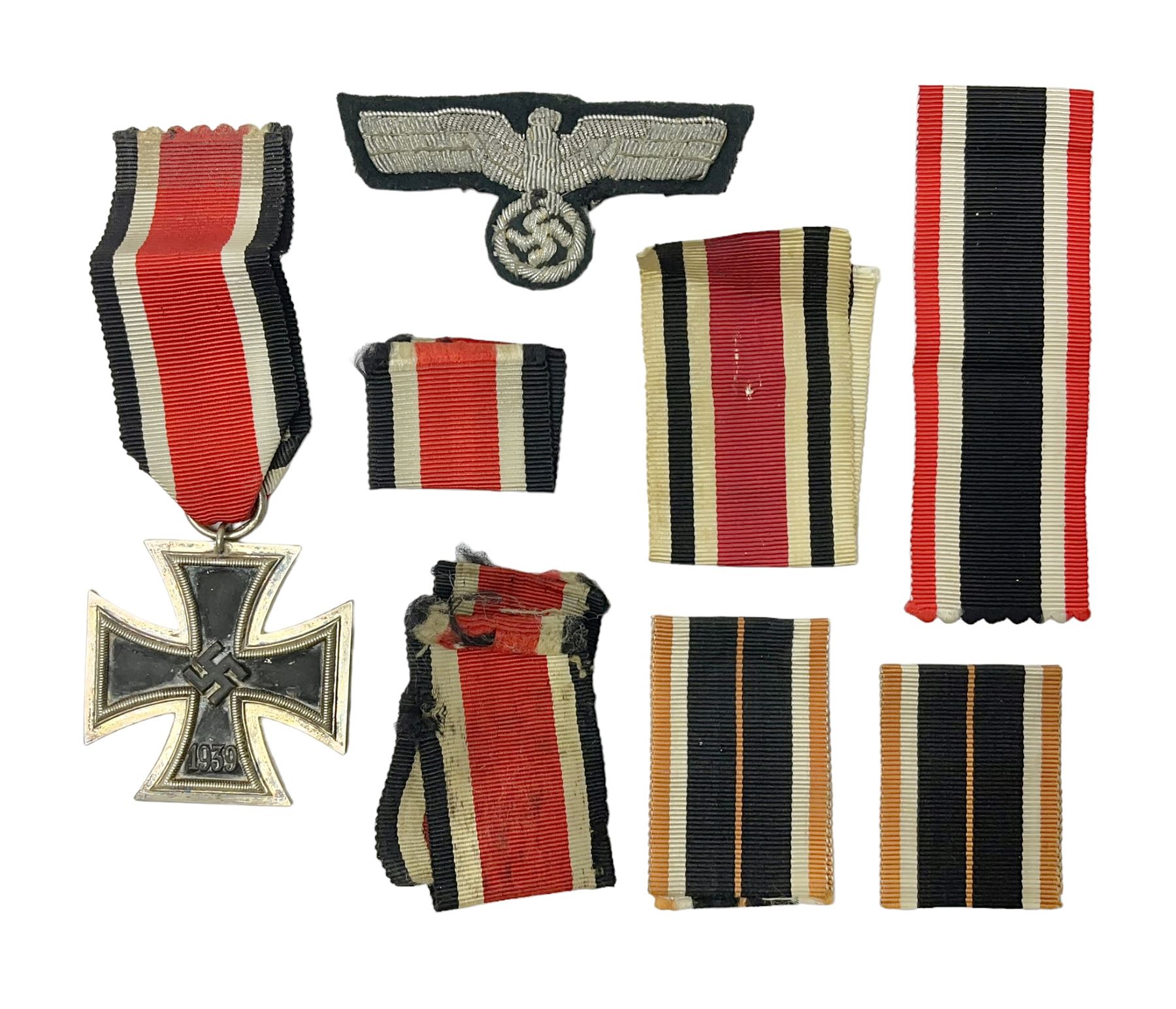 WWII German Iron Cross 2nd Class, the suspension ring stamped 128 for S. Jablonski G.m.b.H. Posen; with ribbon; together with an embroidered cloth eagle badge and quantity of German medal ribbons.